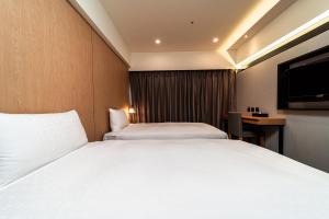 Postel nebo postele na pokoji v ubytování Fish Hotel Kaohsiung