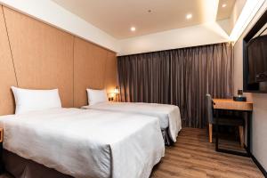Postel nebo postele na pokoji v ubytování Fish Hotel Kaohsiung