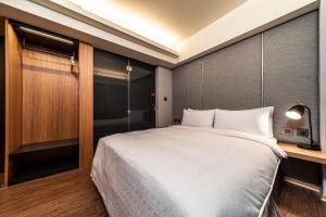 Postel nebo postele na pokoji v ubytování Fish Hotel Kaohsiung