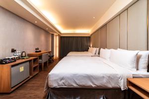 Postel nebo postele na pokoji v ubytování Fish Hotel Kaohsiung