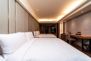 Postel nebo postele na pokoji v ubytování Fish Hotel Kaohsiung