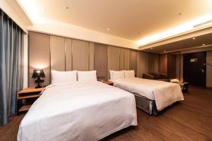 Postel nebo postele na pokoji v ubytování Fish Hotel Kaohsiung