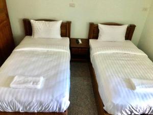 Cama ou camas em um quarto em โรงแรมคูณคีม