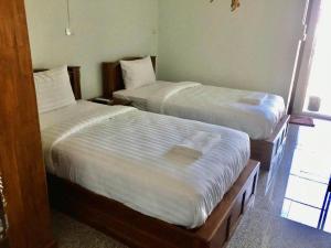 Ein Bett oder Betten in einem Zimmer der Unterkunft โรงแรมคูณคีม