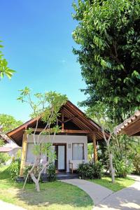 a small house with a wooden roof at Kashantee Village in Seminyak