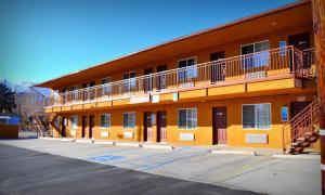 an orange building with a balcony on the side of it at Mount Whitney Motel in Lone Pine