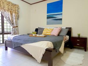 a bedroom with a bed with a tray on it at A famosa Resort Villa with private pool by BeeStay 10 pax in Kampong Alor Gajah