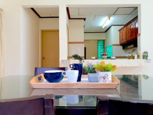 a wooden tray with cups and plants on a table at Melaka Afamosa Villa with Private Pool for 10 pax in Kampong Alor Gajah +14 photos