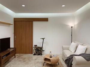 a living room with a couch and a tv at Marlowe-Tony's home in Bangkok