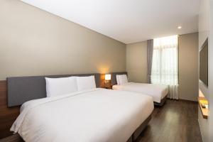 a hotel room with two beds and a window at ENA Suite Hotel Namdaemun in Seoul