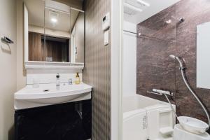 a bathroom with a sink and a shower at BON Condominium Namba Ebisu in Osaka