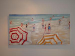 a painting of a beach with people on it at Strandperle in Timmendorfer Strand