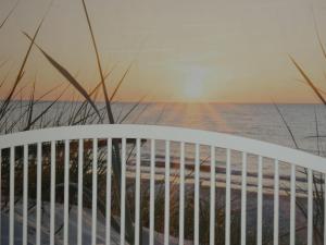 a view of the ocean from a balcony at sunset at Strandperle in Timmendorfer Strand