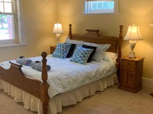 a bedroom with a large bed with blue pillows at Adelaide Style Accommodation - City to Beach - Free WIFI - Free 3 car parking - Great location in Adelaide +58 photos