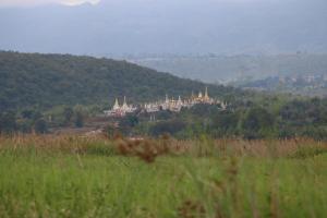 a group of buildings on top of a hill at Sanctum Inle Resort in Nyaung Shwe