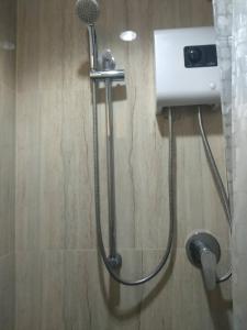 a shower in a bathroom with a blow dryer at Aonang Eco Inn Krabi in Ao Nang Beach