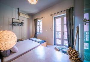 a small room with a bed and a window at Sophia Aegina in Aegina Town