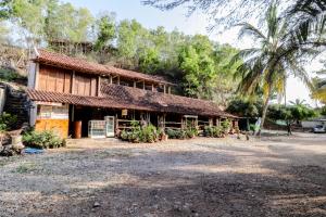 an old house with a straw roof at Penginapan Joko Samudro in Baron