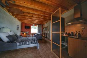 a bedroom with a bed and a living room at Livadi Suites in Arachova