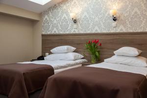 Posteľ alebo postele v izbe v ubytovaní Hotel Maximum