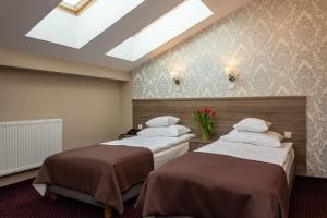 Posteľ alebo postele v izbe v ubytovaní Hotel Maximum