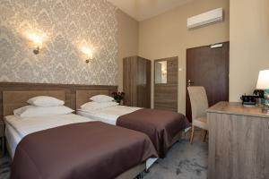 Posteľ alebo postele v izbe v ubytovaní Hotel Maximum
