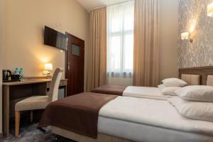 Posteľ alebo postele v izbe v ubytovaní Hotel Maximum