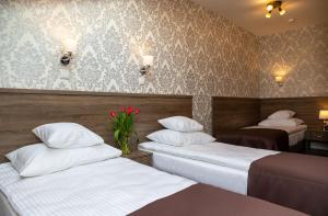 Posteľ alebo postele v izbe v ubytovaní Hotel Maximum