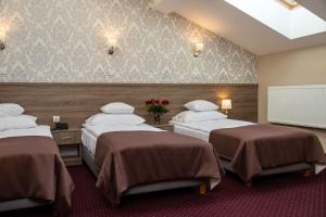 Posteľ alebo postele v izbe v ubytovaní Hotel Maximum