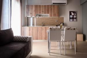 a kitchen with a table and chairs in a room at Haus Viktoria 2 in Limenas +20 photos