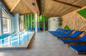 a row of blue lounge chairs next to a pool at Thermal Camping Velingrad in Velingrad