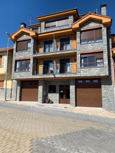 un gran edificio de ladrillo con dos puertas de garaje en Los Casares, en Riaño