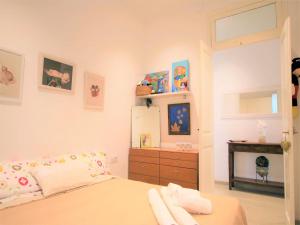 a bedroom with a bed and a dresser and a refrigerator at APARTAMENTO ISAMAR in Calella