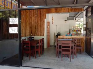 a dining room with a table and chairs at LR Hostel and Cafe in Moalboal