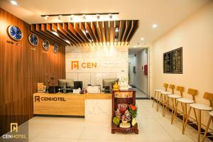 a restaurant with a counter and chairs in a room at Cen Hotel in Vung Tau