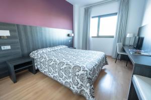 Postel nebo postele na pokoji v ubytování Hotel Abades Via Norte