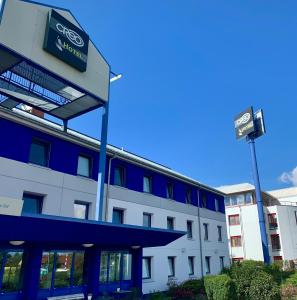 an office building with a sign on top of it at CREO Halle Peissen in Peißen
