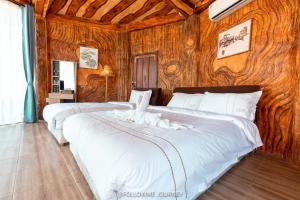 Postel nebo postele na pokoji v ubytování Champathong Garden Resort + 79 fotografií