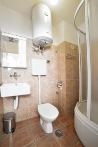 a bathroom with a toilet and a sink and a shower at Hostel Milkaza in Novi Sad