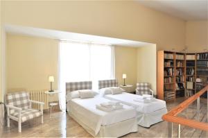 a bedroom with two beds and a large window at SA ROTA Finca en Bunyola 8 personas- Muy tranquilo in Bunyola +41 photos