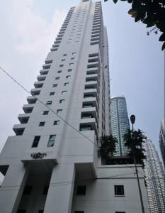 a tall white building with plants on the side of it at Crown Regency Serviced Suites in Kuala Lumpur