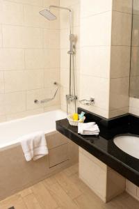 bagno con vasca e lavandino di Sainte Famille Hotel a Kigali