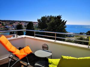 - un balcon avec des chaises et une table donnant sur l'océan dans l'établissement Villa Andrea, à Pula