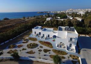 an aerial view of a white building with the ocean at Crystal Mare Suites in Naxos Chora