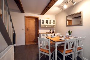 a kitchen and dining room with a table and chairs at Gesindehaus Bornecke in Börnecke