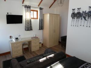 a living room with a couch and a desk at West View Farm in Louth