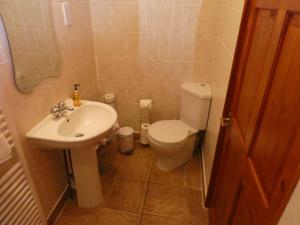 a small bathroom with a toilet and a sink at West View Farm in Louth