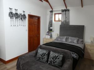a bedroom with a bed and a chair in it at West View Farm in Louth