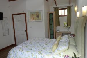 a bedroom with a bed and a window and a mirror at West View Farm in Louth