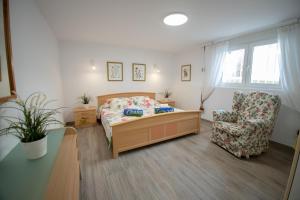 a bedroom with a bed and a chair at ARENDA Villa Amelie en Pino Alto in Miami Platja +58 photos